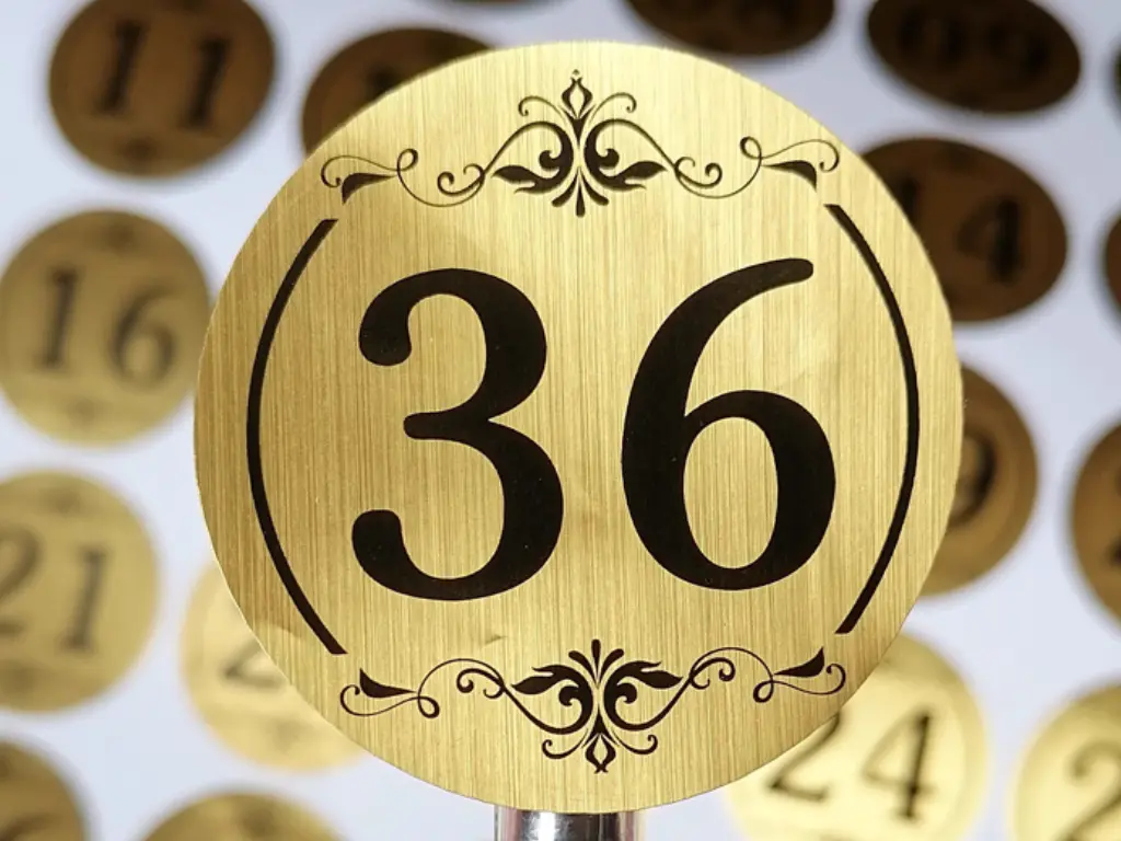 Close-up of the textured finish on a custom brushed gold vinyl sticker.