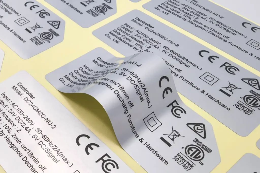 A sheet of rectangular matte metallic silver labels with printed electronic specifications, demonstrating the non-glare finish.