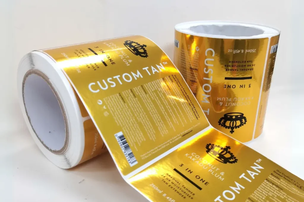 The highly reflective, polished surface of a shiny mirror gold sticker material.